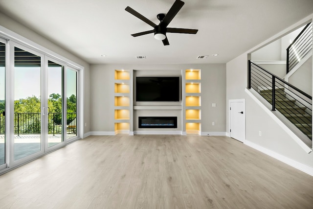 unfurnished living room with ceiling fan, light hardwood / wood-style floors, and built in features