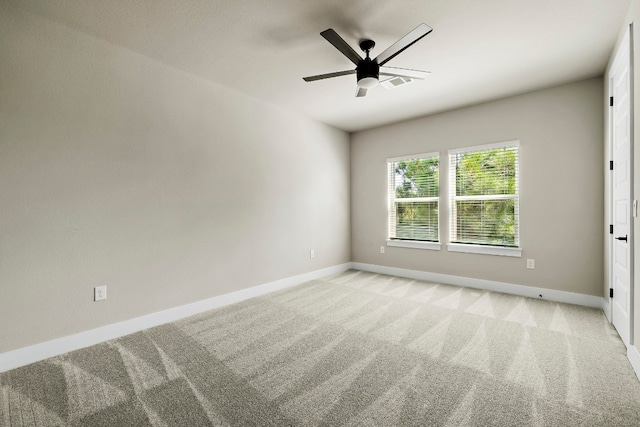 carpeted empty room featuring ceiling fan