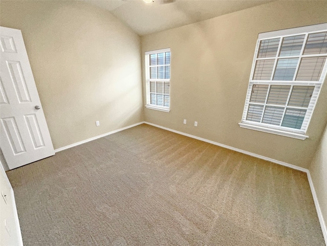 empty room with lofted ceiling and carpet floors