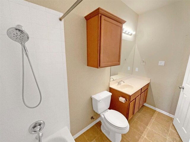 full bathroom featuring vanity, tiled shower / bath combo, toilet, and tile patterned flooring