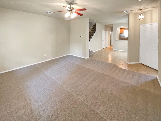 unfurnished living room with ceiling fan and light carpet