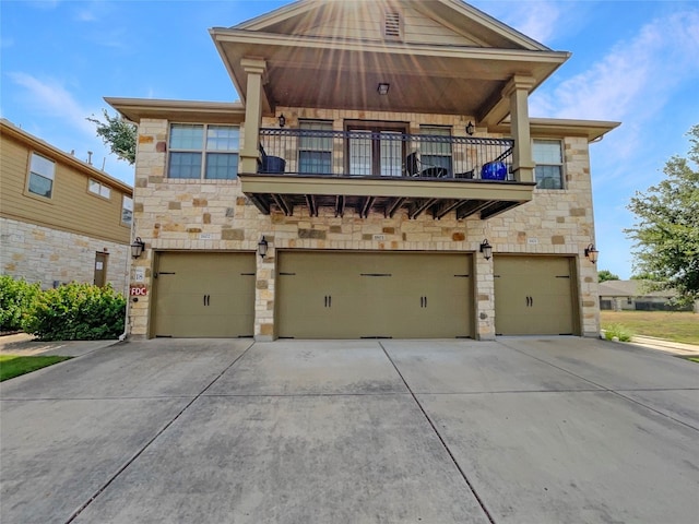 craftsman inspired home with a garage and a balcony