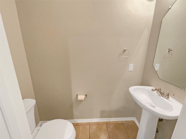 bathroom featuring toilet and tile patterned flooring