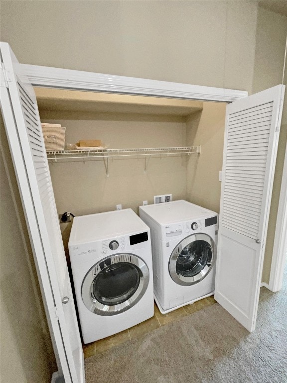 laundry area featuring independent washer and dryer and light colored carpet