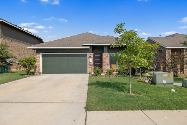 view of front of house featuring a front yard and a garage