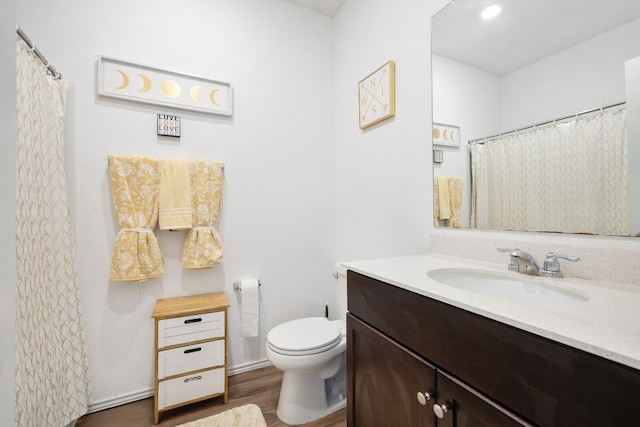 bathroom featuring hardwood / wood-style floors, vanity, and toilet