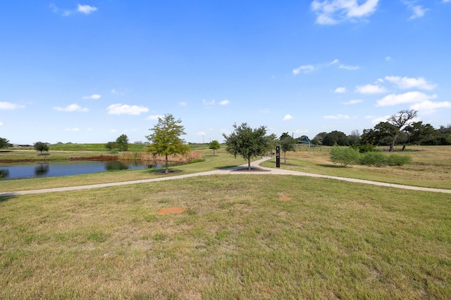 view of community featuring a yard and a water view