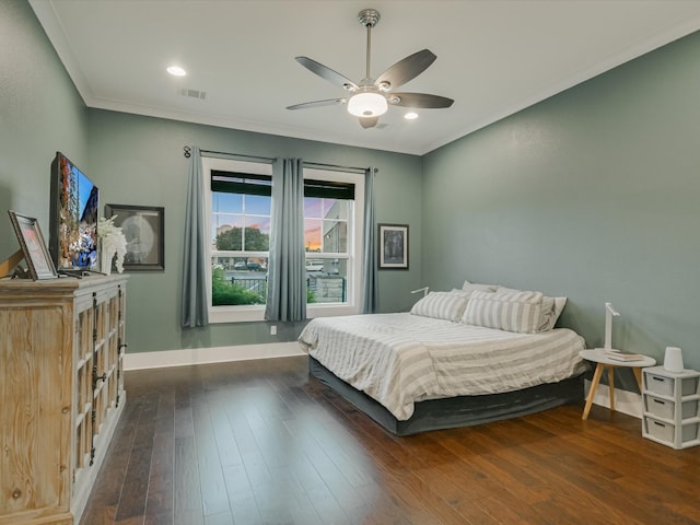 bedroom featuring dark hardwood / wood-style floors, ceiling fan, and crown molding