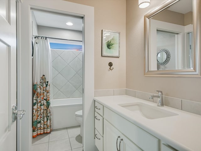 full bathroom featuring tile patterned flooring, vanity, toilet, and shower / tub combo with curtain