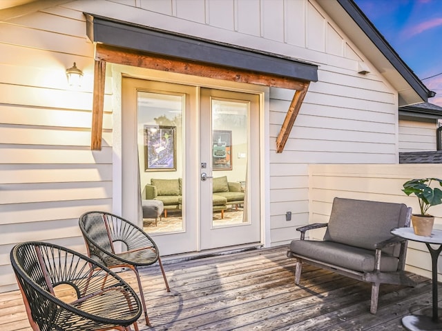 view of exterior entry with french doors and a deck