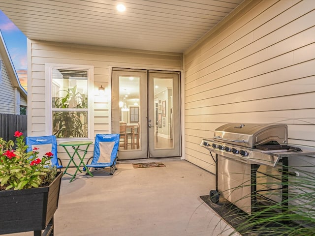 view of exterior entry with a patio area