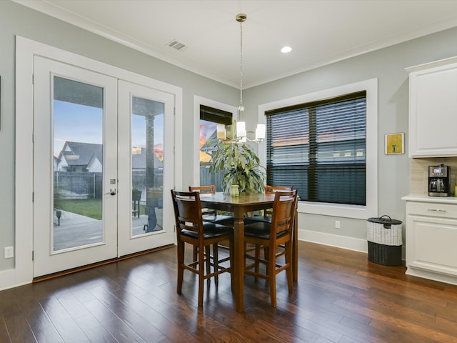 dining room featuring french doors, dark hardwood / wood-style floors, and ornamental molding