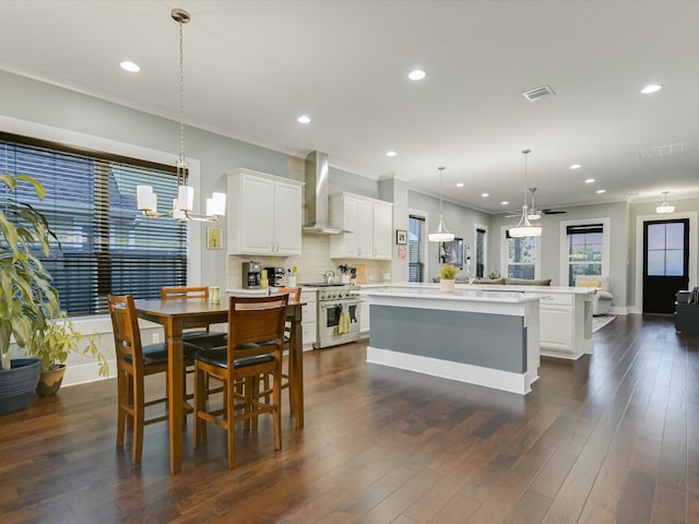 dining area with dark hardwood / wood-style floors and crown molding