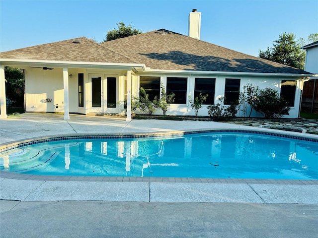 view of pool with a patio area, ceiling fan, and french doors