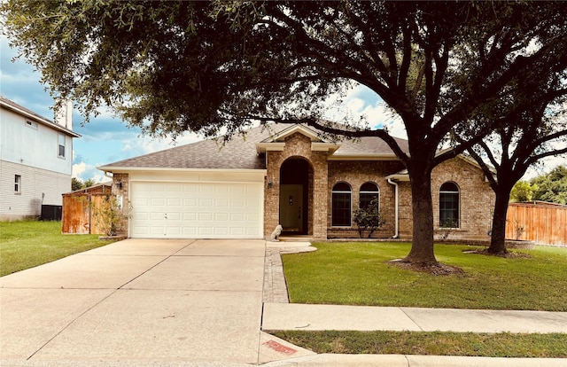 ranch-style house with a garage, a front lawn, and cooling unit