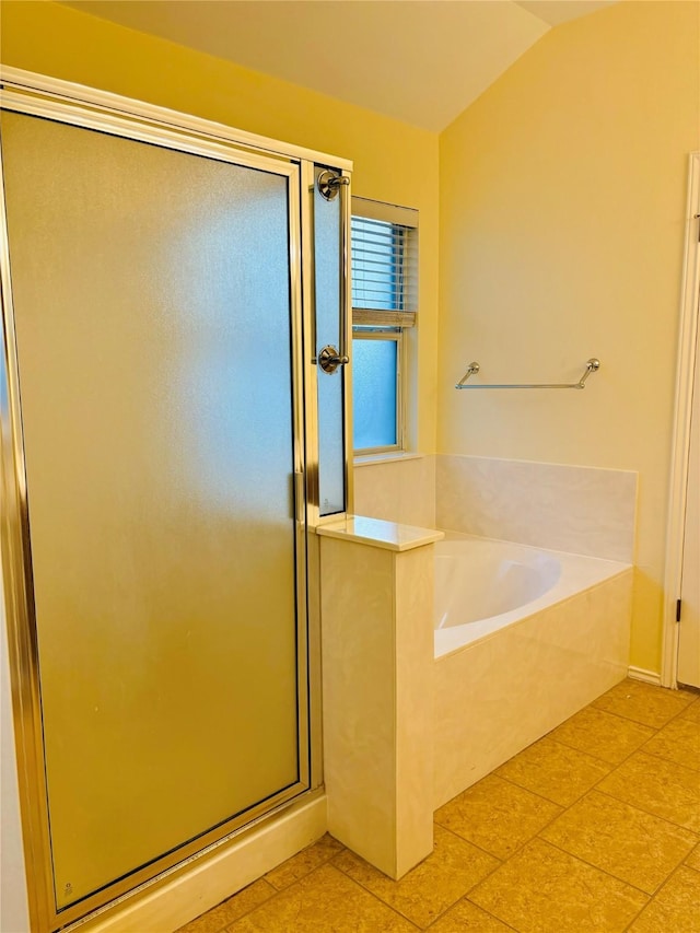 bathroom featuring tile patterned floors, shower with separate bathtub, and vaulted ceiling