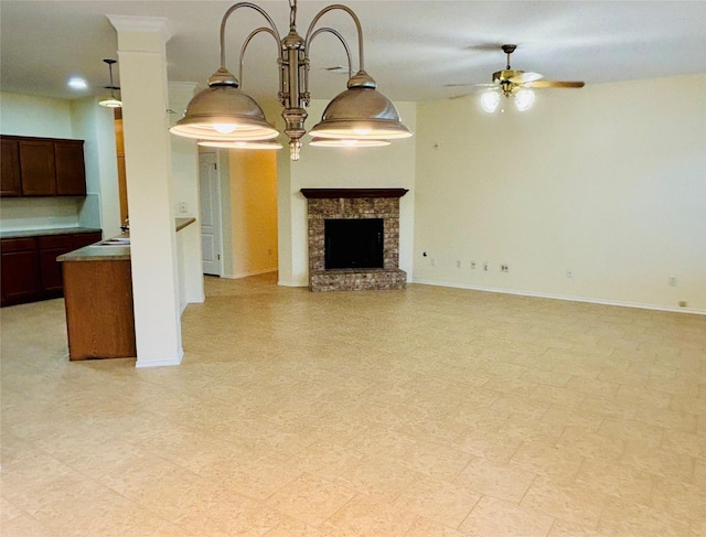 unfurnished living room featuring a stone fireplace and ceiling fan