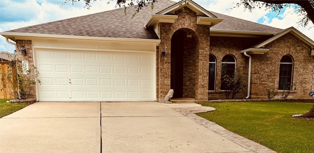 ranch-style home featuring a garage and a front yard