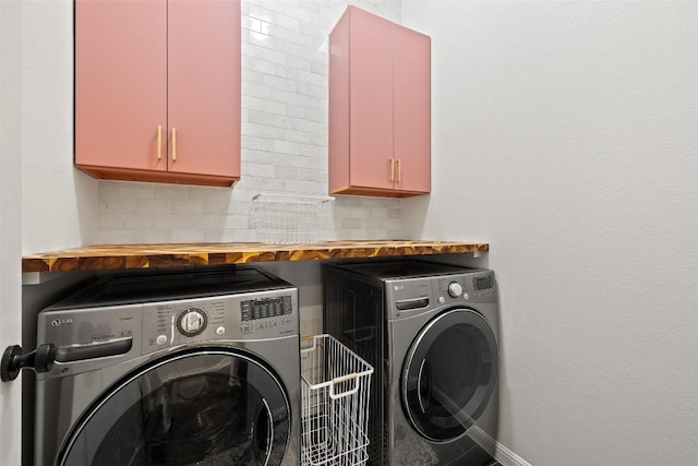 clothes washing area with washer and clothes dryer