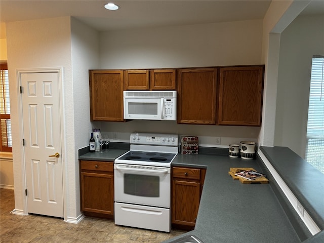 kitchen featuring a healthy amount of sunlight and white appliances