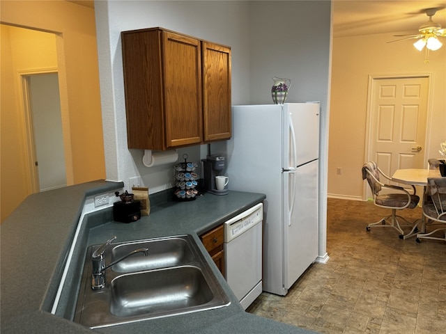 kitchen featuring white appliances, sink, and ceiling fan