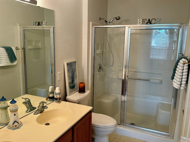 bathroom featuring vanity, toilet, and an enclosed shower