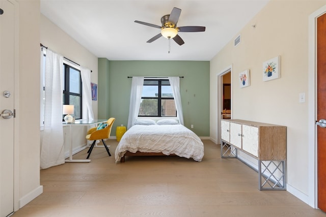 bedroom with ceiling fan and light hardwood / wood-style floors