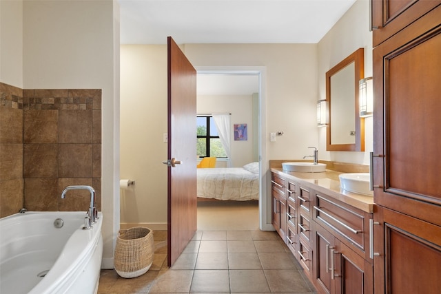 bathroom featuring vanity, tile patterned flooring, and a washtub