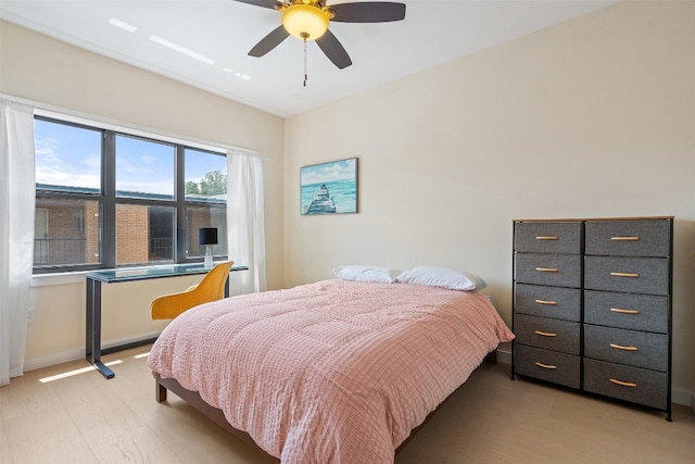 bedroom with ceiling fan and light hardwood / wood-style floors