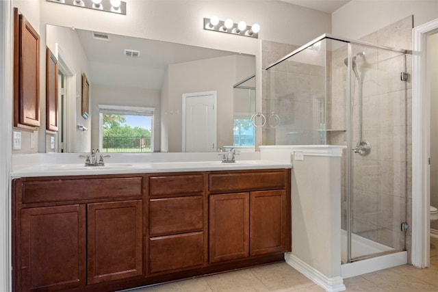 bathroom with walk in shower, tile patterned floors, vanity, and toilet