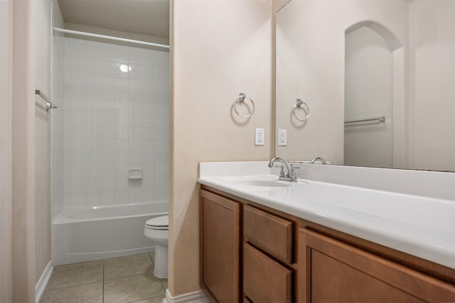 full bathroom with tile patterned flooring, vanity, tiled shower / bath combo, and toilet