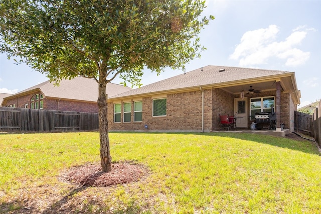 back of house featuring a lawn, a patio area, and ceiling fan