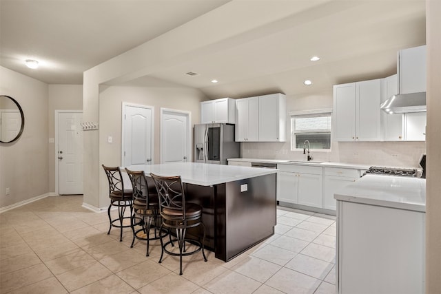 kitchen featuring a center island, a kitchen breakfast bar, sink, white cabinetry, and stainless steel fridge with ice dispenser