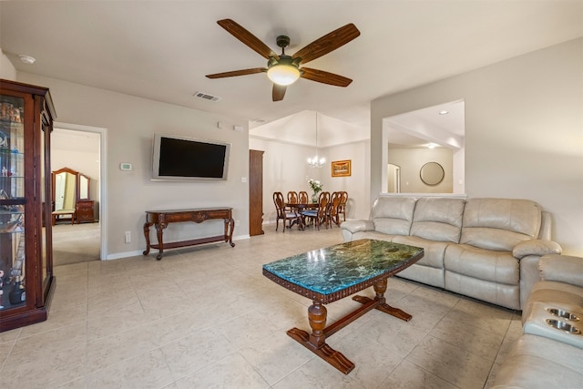 living room with ceiling fan with notable chandelier