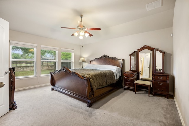 bedroom featuring ceiling fan and light carpet