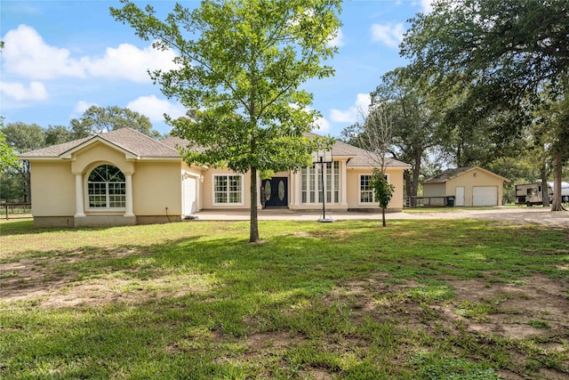 single story home with a front yard and a garage