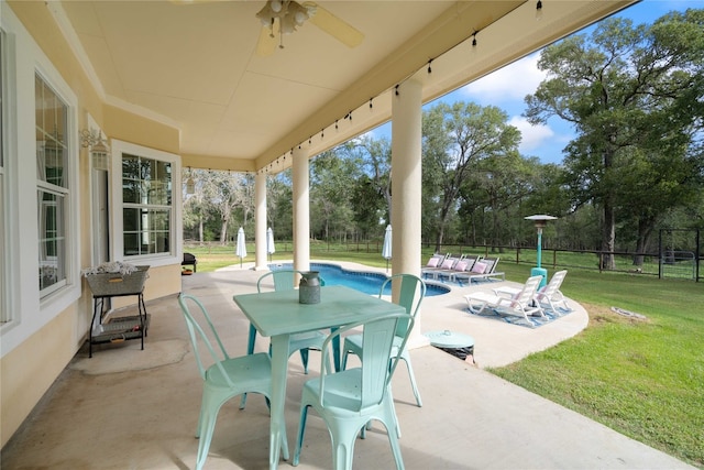 view of patio / terrace with a fenced in pool and ceiling fan