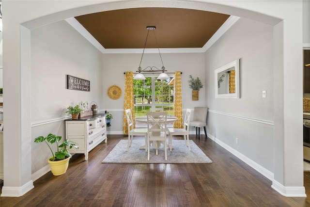 dining room with crown molding and dark hardwood / wood-style flooring