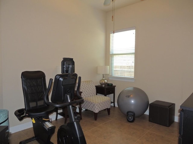 workout room featuring baseboards and tile patterned floors