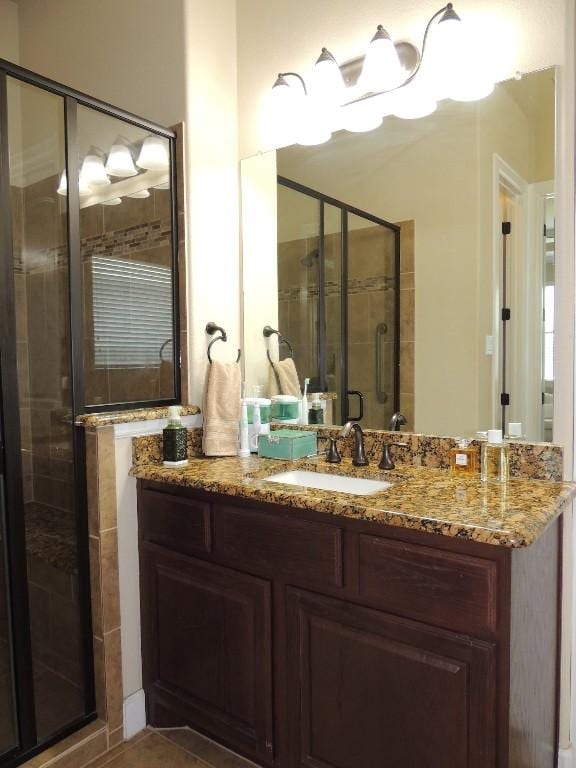 bathroom featuring vanity and a shower with door