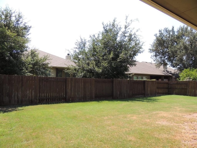 view of yard with a fenced backyard