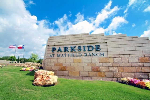 community / neighborhood sign featuring a lawn