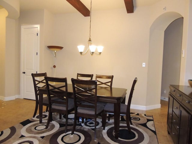 dining area with arched walkways, a notable chandelier, light tile patterned flooring, beamed ceiling, and baseboards