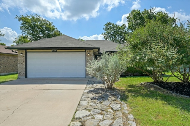 ranch-style home with a garage and a front lawn