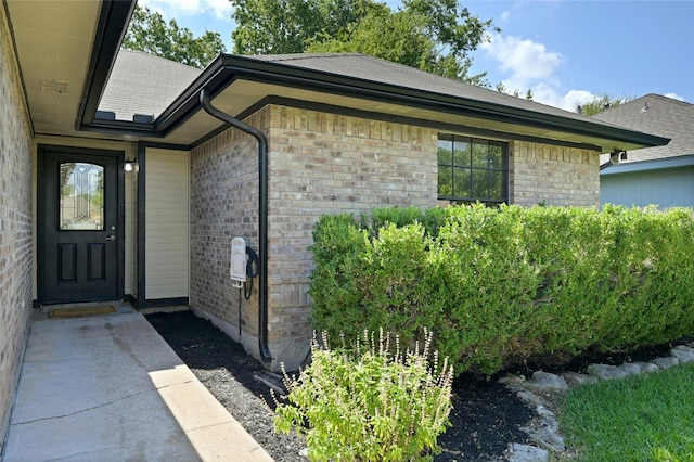 entrance to property with brick siding