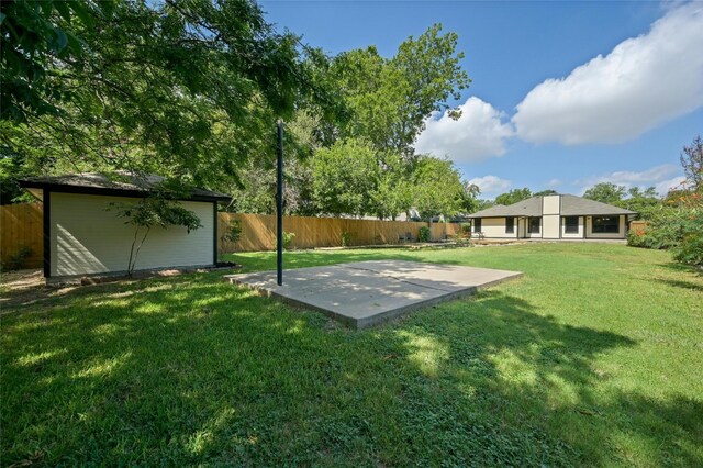 view of yard with a fenced backyard and an outbuilding