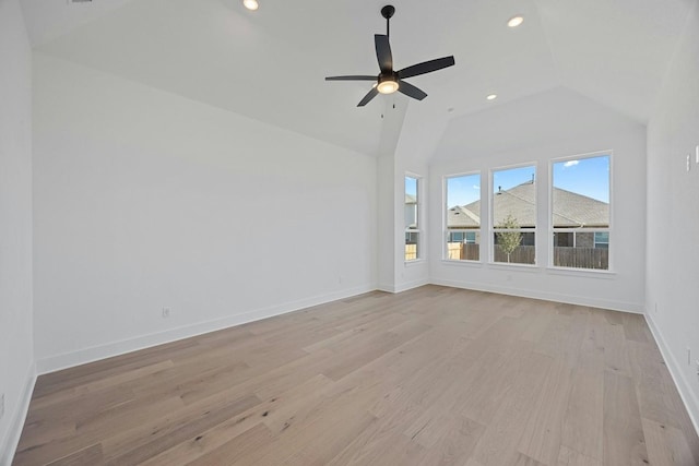 unfurnished living room featuring vaulted ceiling, ceiling fan, and light hardwood / wood-style flooring