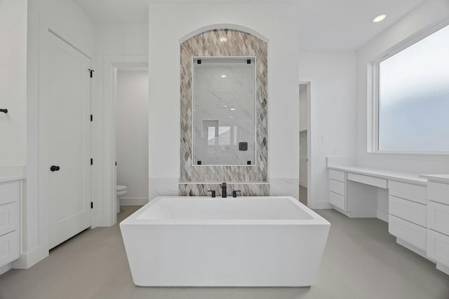 full bathroom featuring toilet, shower with separate bathtub, and vanity