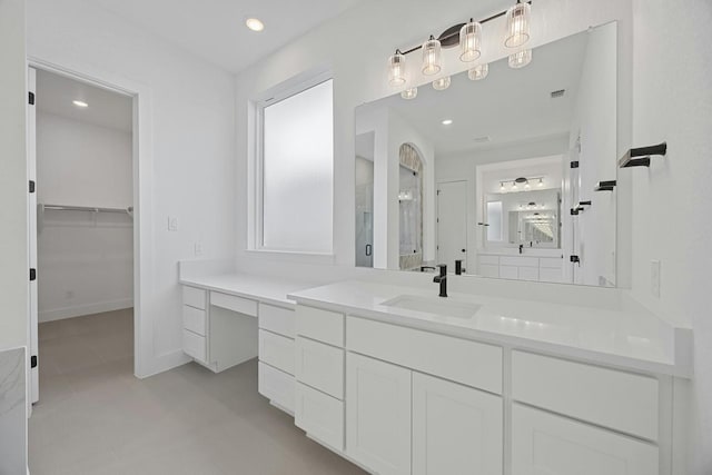 bathroom with vanity, a wealth of natural light, tile patterned flooring, and walk in shower