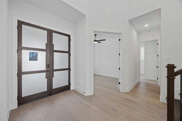 foyer with ceiling fan, light hardwood / wood-style flooring, and french doors